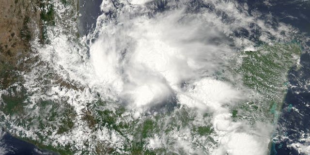 This June 19, 2013 NASA satellite image shows Tropical Storm Barry. An eight-year-old child and his mother were killed in southern Mexico after being swept away in a river during the storm, bringing the death toll to three.