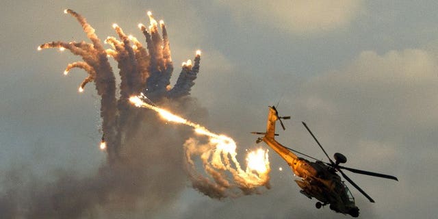 An Israeli Apache helicopter launches anti-missile flares during an air show on December 27, 2012. The Israeli air force attacked targets in the Gaza Strip overnight, following rocket fire from the Palestinian territory into southern Israel, sources from both sides of the conflict said.