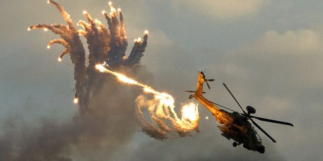 An Israeli Apache helicopter launches anti-missile flares during an air show on December 27, 2012. The Israeli air force attacked targets in the Gaza Strip overnight, following rocket fire from the Palestinian territory into southern Israel, sources from both sides of the conflict said.
