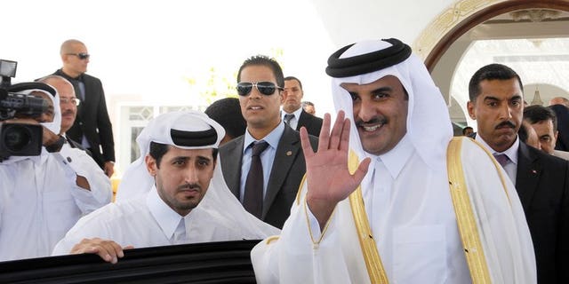 Sheikh Tamim bin Hamad al-Thani waves for photographers upon arrival in Tunis on July 16, 2012. Since his appointment as heir apparent a decade ago, Sheikh Tamim has held top security and economic posts, as well as overseeing Qatar's ambitious plans to use sports to raise its international profile.