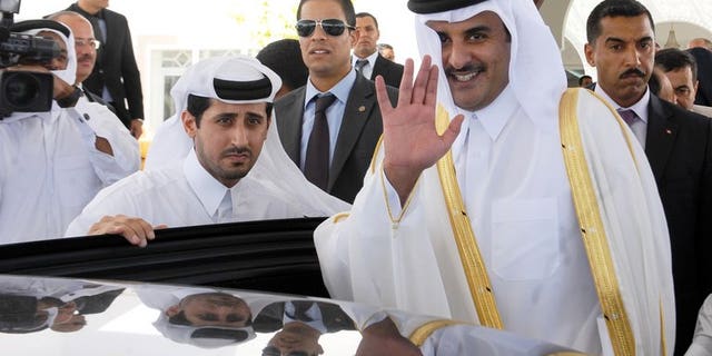 Sheikh Tamim bin Hamad al-Thani waves for photographers upon arrival in Tunis on July 16, 2012. Since his appointment as heir apparent a decade ago, Sheikh Tamim has held top security and economic posts, as well as overseeing Qatar's ambitious plans to use sports to raise its international profile.