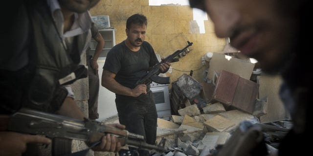Syrian opposition fighters pictured in the northern city of Aleppo on May 27, 2013. Fierce battles raged on the edges of Damascus Tuesday as the army pressed a major assault to crush rebels around the capital, a monitoring group and activists said.