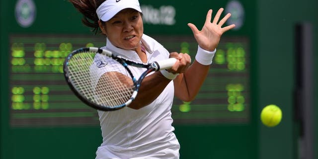 China's Li Na returns against Michaella Krajicek during their women's first round match on day two of the 2013 Wimbledon Championships tennis tournament at the All England Club in Wimbledon, southwest London, on June 25, 2013. Li won 6-1, 6-1.