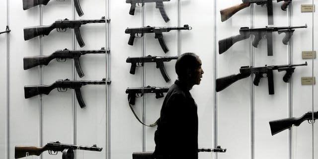 A visitor looks at a display of guns at the military museum in Beijing on June 13, 2006. Defence budgets in the Asia Pacific region will overtake the United States and Canada by 2021, according to a study by respected analysts IHS Jane's published on Tuesday.