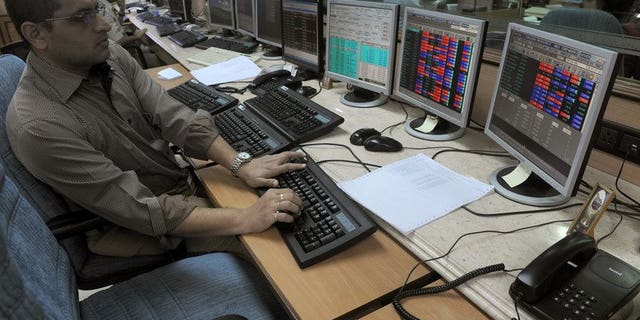 An Indian stockbroker watches share prices on trading terminals at a brokerage house in Mumbai on October 4, 2012. India's market regulator on Tuesday announced an overhaul of existing regulations for foreign investors, in a bid to attract crucial inflows to the country's capital markets.