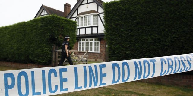 British police stand outside the home of Saad and Iqbal al-Hilli in Claygate, in Surrey, southeast England, on September 14, 2012. British police on Tuesday released on bail a suspect and brother of murdered British-Iraqi man, Saad al-Hilli, who was shot dead along with his wife, mother-in-law and a French cyclist in the Alps last year.