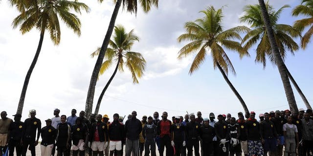 Divers wait on July 1, 2009, by a temporary emergency camp after a plane crash off the northern coast of the Comoros that killed 152 people. A final report into the 2009 crash has found the pilots were to blame for the accident, an investigative commission said on Tuesday.