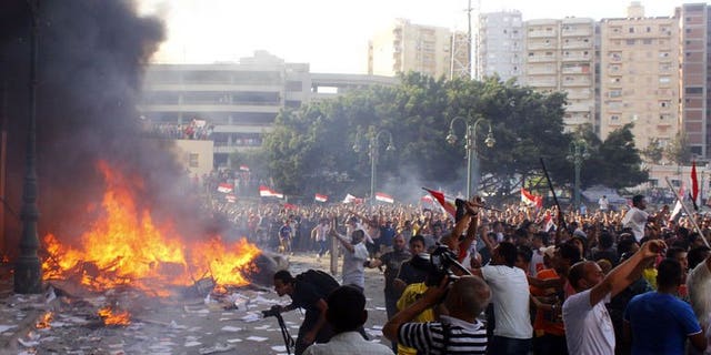 Opponents of Egyptian President Mohamed Morsi burn the content of a Freedom and Justice Party office in the coastal city of Alexandria on June 28, 2013. US President Barack Obama has expressed concern about political clashes in Egypt and called on Morsi to be more "constructive" in moving the country forward.
