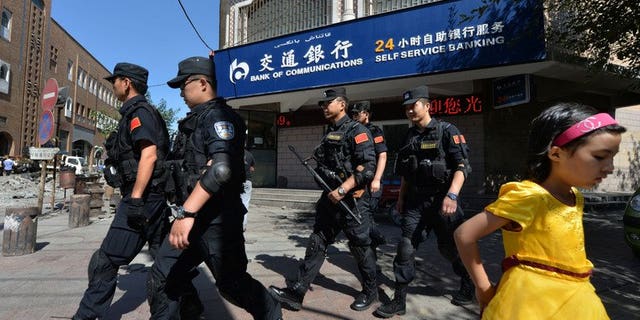 Chinese armed police patrol the streets of the Muslim Uighur quarter in Urumqi on Saturday. China staged a large military exercise in the ethnically-divided Xinjiang region on Saturday, an AFP reporter said, where clashes this week killed at least 35 people.