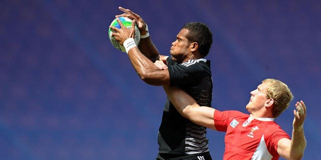 James Davies (right) of Wales vies with Tomasi Cama of New Zealand during their quarter final match at the 2013 Rugby World Cup Sevens in Moscow on June 30, 2013. New Zealand knocked defending champions Wales out of the tournament to set up a semi-final against arch-rivals Fiji.
