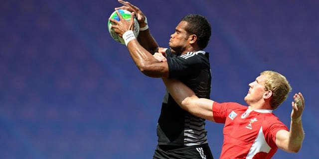 James Davies (right) of Wales vies with Tomasi Cama of New Zealand during their quarter final match at the 2013 Rugby World Cup Sevens in Moscow on June 30, 2013. New Zealand knocked defending champions Wales out of the tournament to set up a semi-final against arch-rivals Fiji.