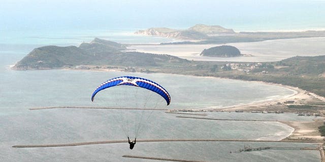 A paraglider flies over the shores of Albanian coastal town of Vlora. Iran on Sunday confirmed the arrest of several Slovaks two days after Bratislava announced that a group of paragliders had been apprehended, reportedly accused of espionage.