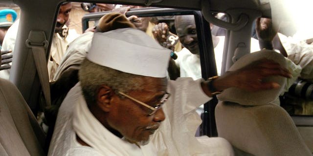 Chad's ex-dictator Hissene Habre leaves Dakar's courthouse escorted by prison guards, November 25, 2005. Habre, detained by Senegal on Sunday in the first step towards a trial for war crimes, is known as "Africa's Pinochet" for his eight-year rule over Chad which began and ended in violence.