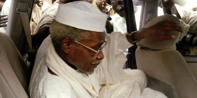 Chad's ex-dictator Hissene Habre leaves Dakar's courthouse escorted by prison guards, November 25, 2005. Habre, detained by Senegal on Sunday in the first step towards a trial for war crimes, is known as "Africa's Pinochet" for his eight-year rule over Chad which began and ended in violence.
