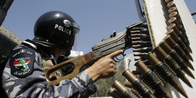 An Iraqi policeman patrols in the eastern Baghdad area of Nahrawan on March 30, 2011. A bombing at a Baghdad football pitch killed nine people Sunday, the majority of them young boys, officials said, the latest in a series of attacks targeting Iraqis playing and watching football.