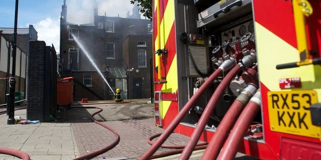 File picture shows firefighters trying to extingush a blaze in north London on August 7, 2011. More than 200 firefighters were on Monday battling a major blaze at a British recycling plant after 100,000 tonnes of paper and plastic caught fire, sending a plume of smoke rising into the sky which could be seen for miles around.