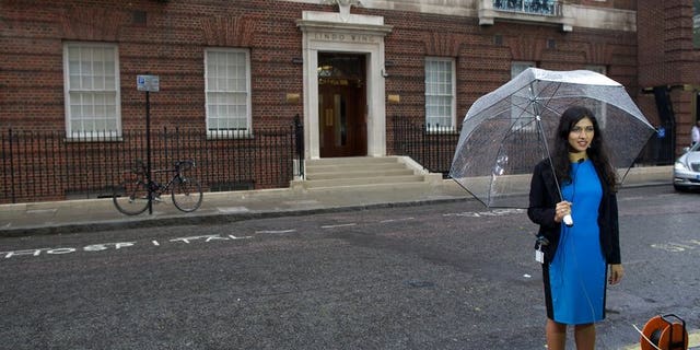 A reporter prepares to go on camera outside the Lindo Wing at St Mary's Hospital in London on June 20, 2013. Prince William's wife Catherine is not officially due to give birth for two weeks but the world's media began gathering outside the London hospital where she will have the baby, determined not to miss the photograph of the year.
