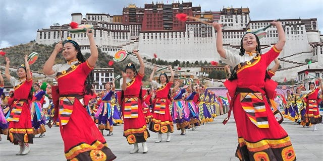 Tibetan performers dressed in traditional costume perform in Lhasa on June 21, 2008. The controversial renovation of the historic area around a key monastery in the Tibetan capital has been completed, Chinese state media said.