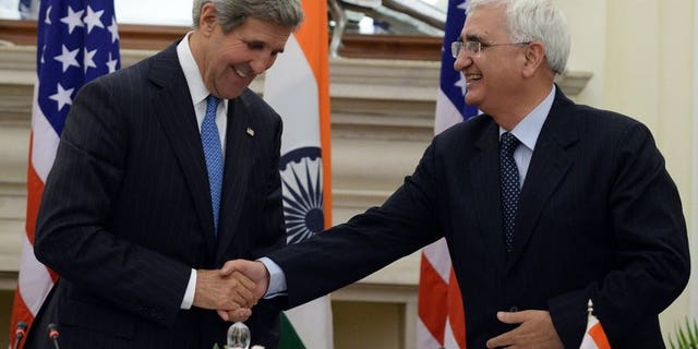 US Secretary of State John Kerry (L) shakes hands with India's foreign minister, Salman Khurshid, after a press conference in New Delhi, on June 24, 2013. Khurshid on Tuesday defended the vast US surveillance programme of phone logs and Internet data revealed by intelligence leaker Edward Snowden.