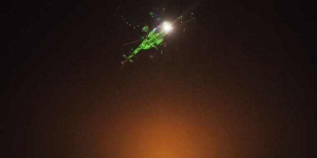 Egyptian protesters direct laser lights on a military helicopter flying over the presidential palace in Cairo, on July 1, 2013. Iran on Tuesday called on the Egyptian military to support national reconciliation and respect the "vote of the people" after it warned it was ready to intervene in Egypt's political crisis.