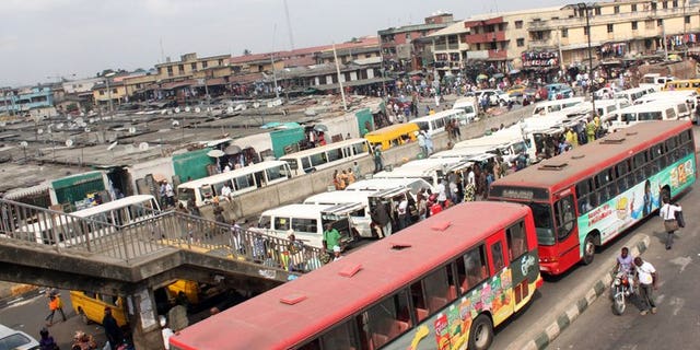 Buses are seen near a market in Lagos on February 1, 2012. Long queues have formed at petrol stations in some Nigerian cities after a key oil workers union ordered a three-day strike to demand better conditions and road repairs.