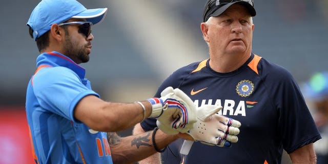 Indian captain Virat Kohli (left) confers with coach Duncan Fletcher before the start of the Tri-Nation one-day match against Sri Lanka at the Sabina Park stadium in Kingston, on July 2, 2013. Indian won the toss and elected to field.