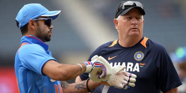 Indian captain Virat Kohli (left) confers with coach Duncan Fletcher before the start of the Tri-Nation one-day match against Sri Lanka at the Sabina Park stadium in Kingston, on July 2, 2013. Indian won the toss and elected to field.