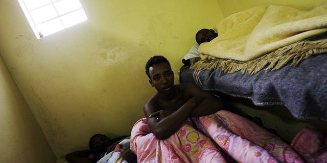 Sick Somali foreign nationals lay cramped in a toilet at a temporary refugee camp in Soetwater on the outskirt of Cape Town on June 18, 2008. A Somali envoy on Tuesday met officials in Pretoria in a bid to ease tensions stirred by recurring attacks on Somali refugees in South Africa.