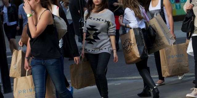 Shoppers walk along Oxford Street on April 25, 2013. Britain faces a "20-year generational battle" to restore financial stability and "at least" four more years of austerity measures, the country's top civil servant warned Tuesday.