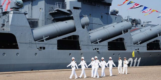 Chinese sailors march past the Russian destroyer Admiral Vinogradov, in Qingdao, northeastern China, on April 23, 2012. China and Russia will hold their second joint naval exercises from Friday, state media said, as Beijing and Tokyo row over disputed islands in the East China Sea.