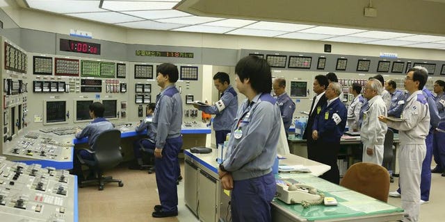 Workers at Oi nuclear power plant stand to attention on July 9, 2012. Japan's nuclear watchdog said the only two reactors currently working in the country -- at Oi -- can stay online for now.