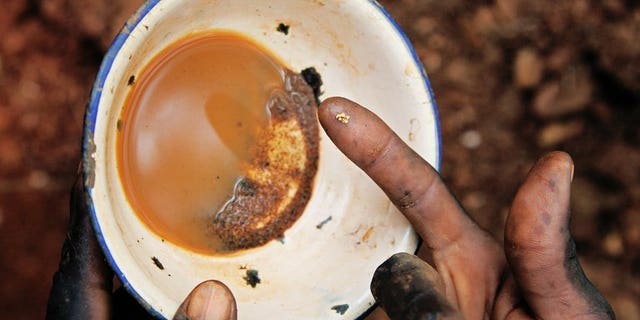 File picture shows a South Sudanese worker holding a speck of gold in Nanakanak in Greater Kapoeta, South Sudan, on May 8, 2013. A clash between Sudanese police and villagers over a gold mine killed one person and wounded several others, residents told AFP on Wednesday.