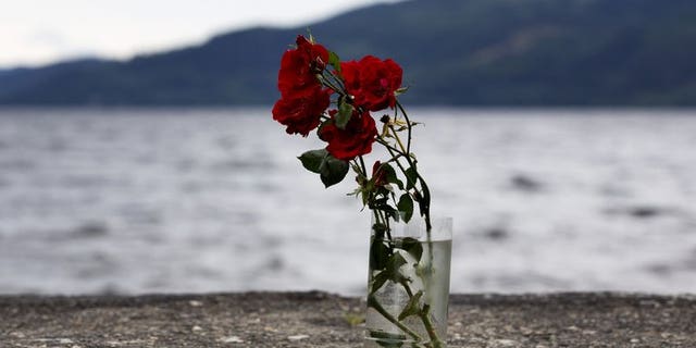 Flowers in a vase are pictured on the shores of Utoeya Island on July 22, 2012 where Anders Behring Breivik killed dozens at a Labor Party summer camp. The camp reconvened at a new site for the first time.