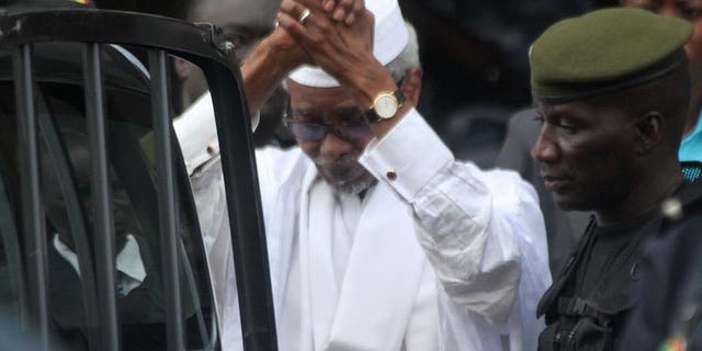 Former Chadian dictator Hissene Habre is escorted by military officers on July 2, 2013 in Dakar. Habre is refusing to recognise a tribunal set up in Senegal to try him for genocide over the deaths of up to 40,000 people during his eight-year rule, his lawyers said on Wednesday.