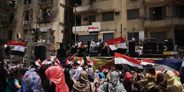Egyptians cheer and wave their national flag as they gather in Cairo's landmark Tahrir Square on July 4, 2013. Governments across the Middle East have welcomed the ouster of Egypt's Islamist president Mohamed Morsi with varying degrees of enthusiasm, with war-hit Syria calling it a "great achievement".