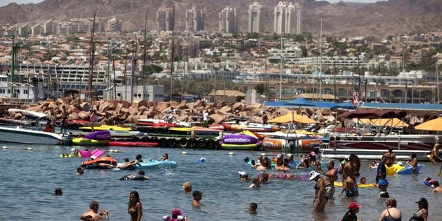 Tourists enjoy the beach in the Red Sea Israeli resort city of Eilat on August 19, 2011. Several explosions were heard Thursday night in Eilat near the Egyptian border, a police spokesman said, adding that the source of the blasts was not known.