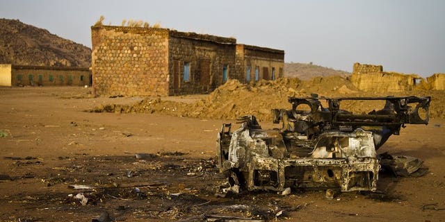 The shell of a vehicle that was hit by a bomb in the abandoned village of Trogi during fighting in South Kordofan, Sudan, is pictured on April 3, 2012. An advance party of UN troops who will support the monitoring of a buffer zone along the disputed Sudan-South Sudan border should arrive by August, the top UN peacekeeper said on Thursday.