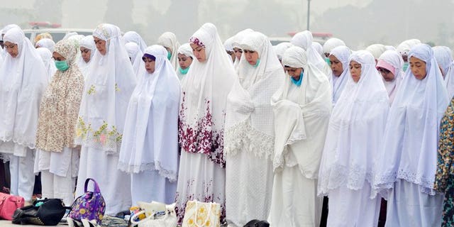 Indonesian Muslim women take part in mass prayers asking for rain at a square covered by thick haze in Dumai on June 25, 2013. Sales and distribution of alcohol could be banned in some parts of Indonesia after Muslim hardliners won a Supreme Court victory, an official said Friday.