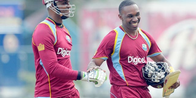 Dwayne Bravo (right) and Marlon Samuels leave the field after West Indies beat Sri Lanka in Kingston on June 28. West Indies captain Dwayne Bravo won the toss and put India in to bat in the fourth match of the Celkon Mobile Cup Tri-Nation Series at Queen's Park Oval on Friday.