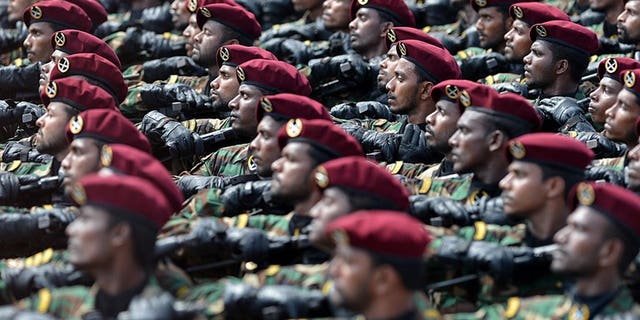 Sri Lankan commandos march during a Victory Day parade in Colombo on May 18, 2013. Sri Lanka's police arrested 12 commandos in connection with the execution-style killing of five students during the island's Tamil separatist war, an official said Friday.