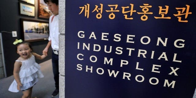 Visitors look around a showroom of North Korea's Kaesong joint industrial complex, at a South Korean observation post near the Demilitarized Zone dividing the two Koreas on June 6, 2013.