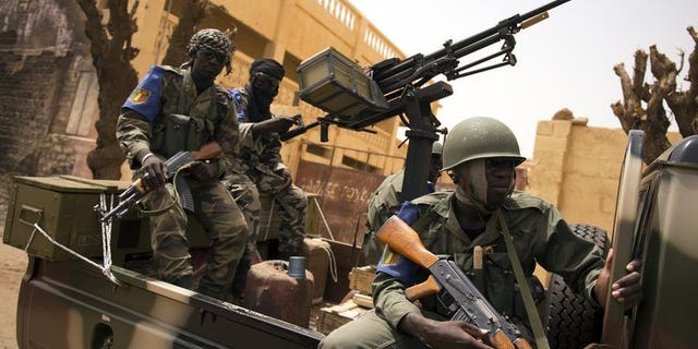 Malian soldiers patrol in the streets of Gao on June 13, 2013. Mali has lifted a five-month state of emergency, on the eve of the start of a presidential election campaign for July 28 polls in the troubled west African nation.
