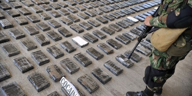 A soldier guards a huge shipment of cocaine seized in a clandestine laboratory, on March 16, 2013, in Tumaco, Colombia. An Italian mafia capo alleged to be the biggest cocaine trafficker in the world will be deported to Italy, a day after being arrested in a Colombian shopping mall, prosecutors said.