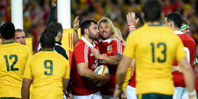 Alex Corbisiero (centre L) is congratulated by Richard Hibbard (centre R) after scoring a try in Sydney on Saturday.