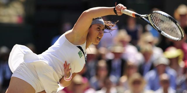 Marion Bartoli serves against Sabine Lisicki at Wimbledon on Saturday. Marion Bartoli romped to her first Grand Slam title as the French 15th seed thrashed Germany's Sabine Lisicki 6-1, 6-4 in the Wimbledon final on Saturday.