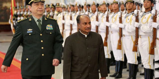 Indian Defence Minister AK Antony (R) inspects a tri-Services guard of honour with his Chinese counterpart, General Chang Wanquan in Beijing on July 5, 2013. The Chinese and Indian defence chiefs agreed Saturday to strengthen "peace and tranquility" along their frontier, state media reported, as the countries work to keep tensions in a disputed border area in check.