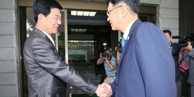 A picture released by South Korea's Unification Ministry, shows Suh Ho (R), head of the S.Korean working-level delegation, meets his N.Korean counterpart Park Chol-Su, in the truce village of Panmunjom, on July 6, 2013. North and South Korea agreed Sunday to inspect a joint industrial zone shuttered amid high cross-border tension and to hold talks on preventing another closure, reports said.
