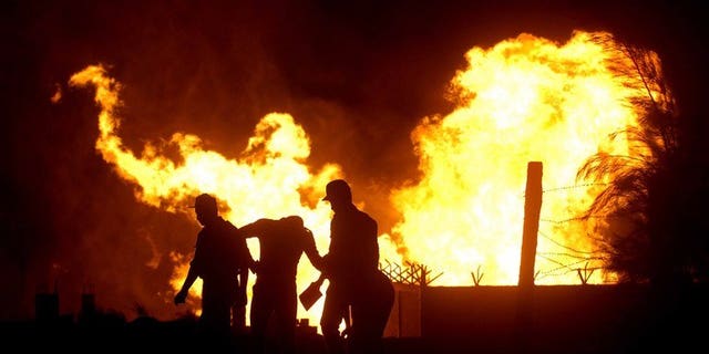 File picture of a fire at al-Arish in the north of the Sinai peninsula following an attack on a gas pipeline. Militants in Egypt's Sinai Peninsula bombed a gas pipeline to Jordan on Sunday, witnesses said, amid a surge in attacks on police and soldiers since Islamist president Mohamed Morsi's removal.