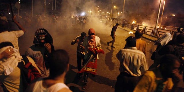 Egyptian supporters of the Muslim Brotherhood clash with police outside the elite Republican Guards base in Cairo early on July 8, 2013. The Brotherhood said on Monday that 35 supporters of ousted president Mohamed Morsi were killed at dawn when security forces opened fire on them as they were praying.