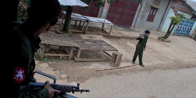 Soldiers stand guard after riots broke out in Lashio, eastern Myanmar, on May 30, 2013. Myanmar has discharged 42 children and young people from its armed forces, UN agencies has said, urging increased efforts to free child soldiers as the country emerges from military rule.